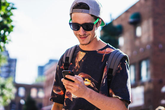 Young man looking at mobile phone stock photography