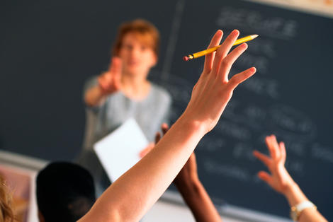 Student raising hand in class stock photography